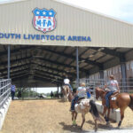 Competitors riding their horses into the MFA Youth Livestock Arena