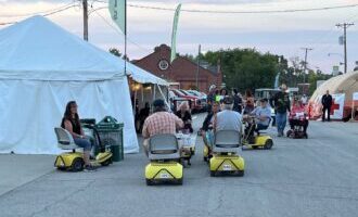 Scooter rental tent with several customers outside