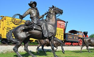 Bronze sculpture of a cowboy on a horse at the Trails End Landmark