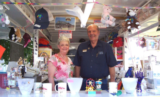 Two volunteers selling items at the fair